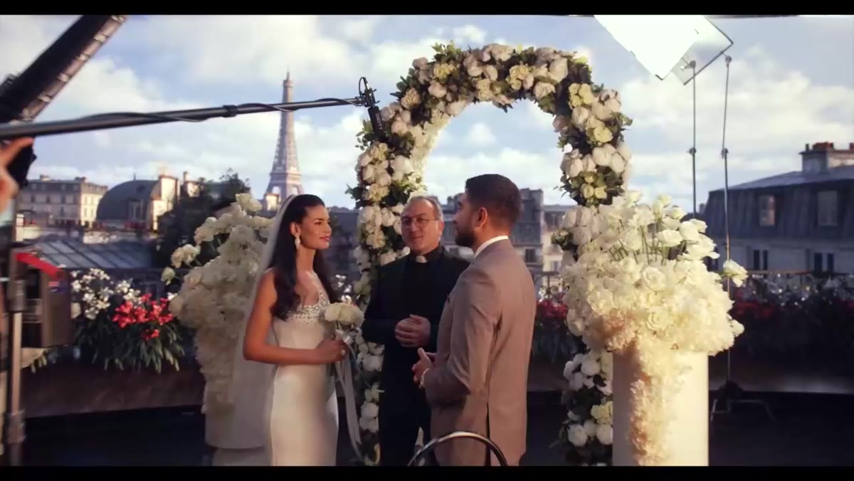 A wedding ceremony with lighting equipment visible on set